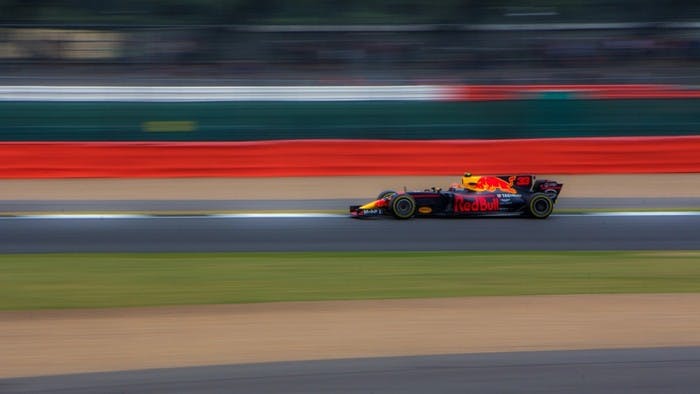 Formula 1 race car driving fast on track